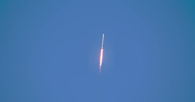 Missile flying into sky in 4K at  120 fps slow motion.  Lots of nice flames and smoke against a clear blue sky.