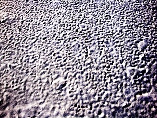 Beautiful white snow texture, formed by the winter wind. Waves and Dunes