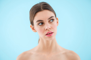 Fototapeta premium Beautiful young woman posing isolated over blue background.