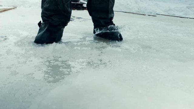 man working on the ice with tools