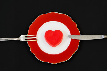 Red heart on a red plate.