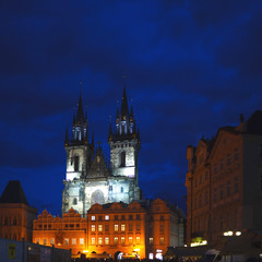 Fototapeta na wymiar Two Gothic towers of the Church of our lady in the illumination late at night. Tyn Church