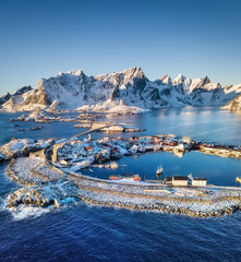 Aerial view at the Lofoten islands, Norway. Mountains and sea during sunset. Natural landscape from air at the drone. Norway at the winter time