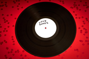 Valentines Day background with black LP record with love songs on red background