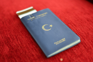 Turkish blue passport on red canvas background
