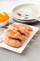 Minced turkey kebabs on square white plate