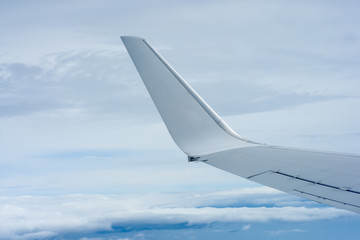 Obraz premium KUALA LUMPUR, MALAYSIA-OCTOBER 30 2018:The wing of Malaysia Airline MAS fleet views from a window during flight time over the blue sky