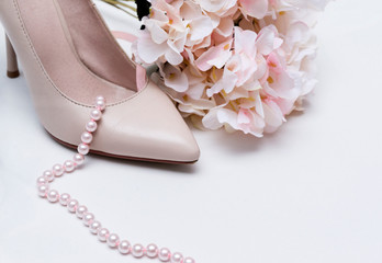 white women's boat Shoe, pink pearl necklace, rose hydrangea flower