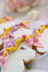 Unicorn royal icing cookies; food background