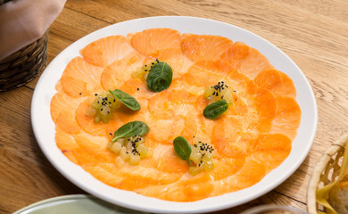 pieces of trout on a plate of greens