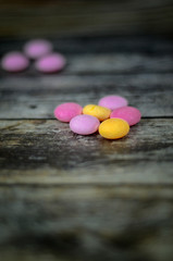 Colorful pills on wooden background