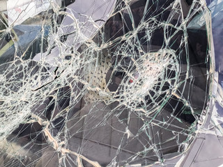 Car windshield shattered with stones by vandals.