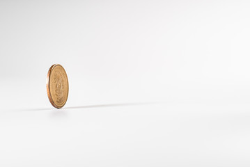 Dollar coin rotating on white background, concept of American economy.