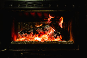 Firelogs burning in a fireplace in winter.