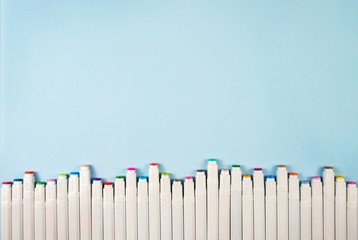 Markers for drawing on a blue background.