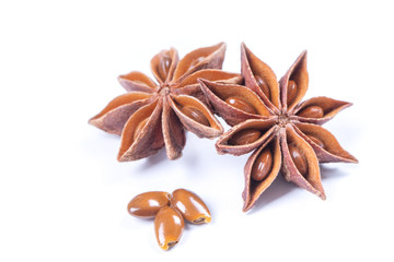 Star anise spice fruits and seeds isolated on white