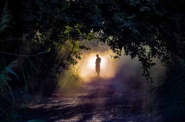 man silhouette standing in the fog 