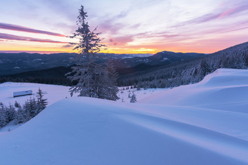 Colorful winter dawn on the mountain valleys in the Ukrainian Carpathian Mountains.