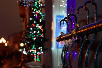 Icicles hanging in a street during christmas time at night. Colorful bokeh background. Arbat Street, Moscow.