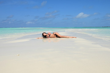 Fototapeta na wymiar Sensual woman sunbathing in paradise.