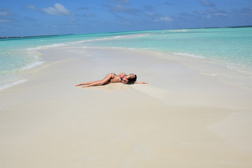 Fototapeta na wymiar Sensual woman sunbathing in paradise.