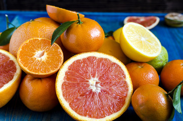 Tangerines lemons oranges lime citrus close-up on blue background copy space