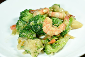stir fried broccoli with shrimp and crispy chicken on dish