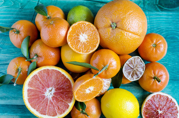 Tangerines lemons oranges lime citrus close-up on green background copy space