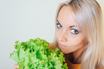 Portrait of an attractive girl with a salad Bush. Dieting concept.