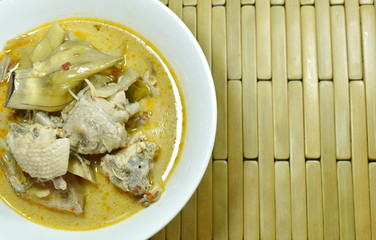 spicy boiled banana blossom with chicken in coconut milk soup on bowl