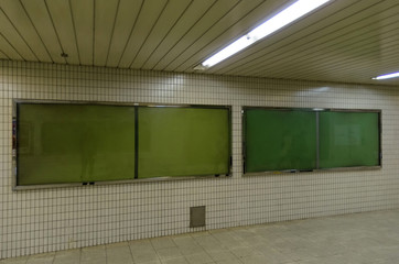 big blank advertising billboard on wall with copy space for your text message or media and content in subway train station or airport, information board, banner, marketing and advertising concept