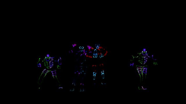 4 people dancing in costumes of LEDs