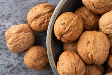 Bowl of walnuts with nuts to the side