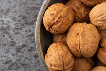 Bowl of walnuts on a gray background