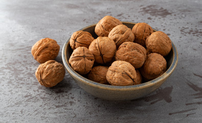 Bowl of walnuts with two to the side