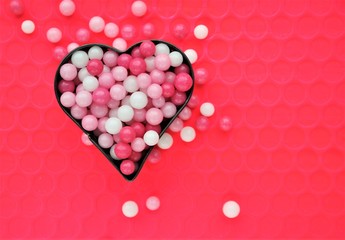 Valentines day background with heart shape filled with sweets in pink and white colors. love concept with copy space