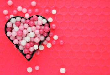 Valentines day background with heart shape filled with sweets in pink and white colors. love concept with copy space