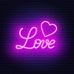 Love neon lettering on brick wall background.