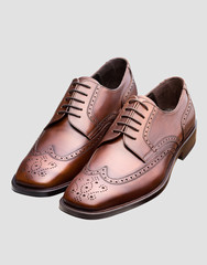 pair of brown leather shoes isolated on white background