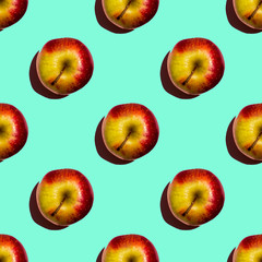 Seamless pattern of apples on green background