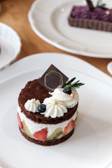 Chocolate cake with whip cream and fruit. .
