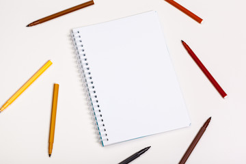 paper and colorful felt tip pens on the white table