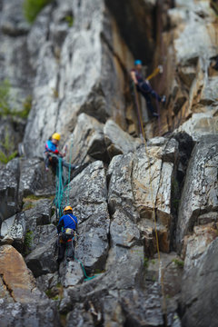  A group of climbers working on a complex rocky site. Tilt-Shift effect.