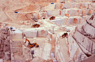 View of marble quarry with machinery and quarry equipment. White marble mining, Carrara