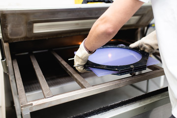 Disabled man working in amputee shop for production prosthetic extremity parts.