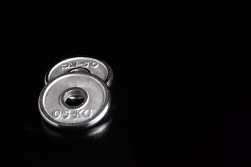 Extra Weight for Dumbbells on Black Background