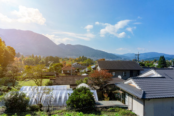 The View of Yufuin countryside with Mount Yufu in Background and blue sky with clouds in autumn season. onsen town, Yufuin, Oita, Kyushu, Japan