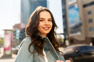 people concept - happy smiling young woman or teenage girl on summer city street