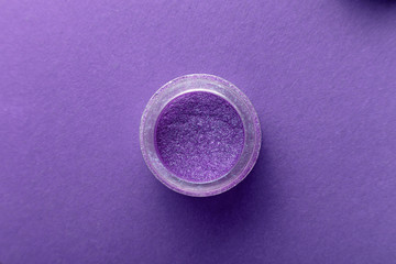 jar with pigment fashionable shade ultra violet on a colored background