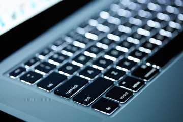 Keyboard laptop. Backlit computer keyboard closeup. Hi tech concept